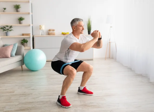 man performing bodyweight squats