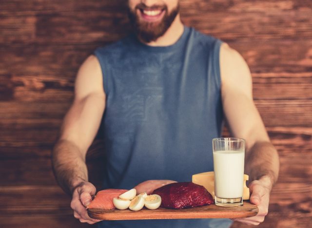 a man holding a tray of proteins