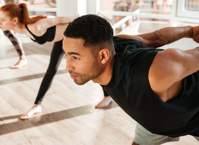 man in hot yoga class demonstrating exercises men should avoid to regain muscle