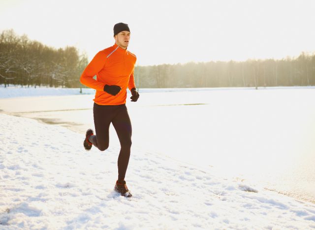 fitness man jogging in the snow, demonstrating what happens to your body when you jog more