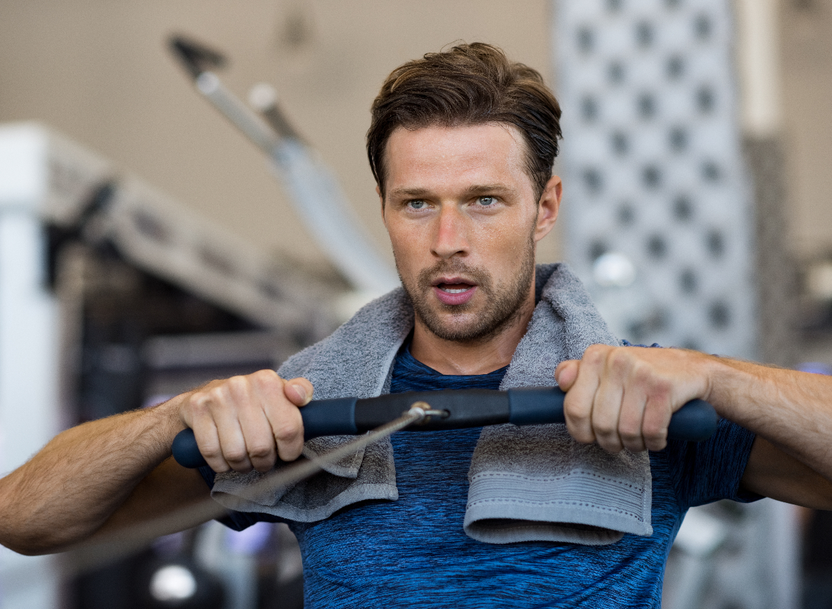 fit man on rowing machine demonstrating exercise habits for strong forearms