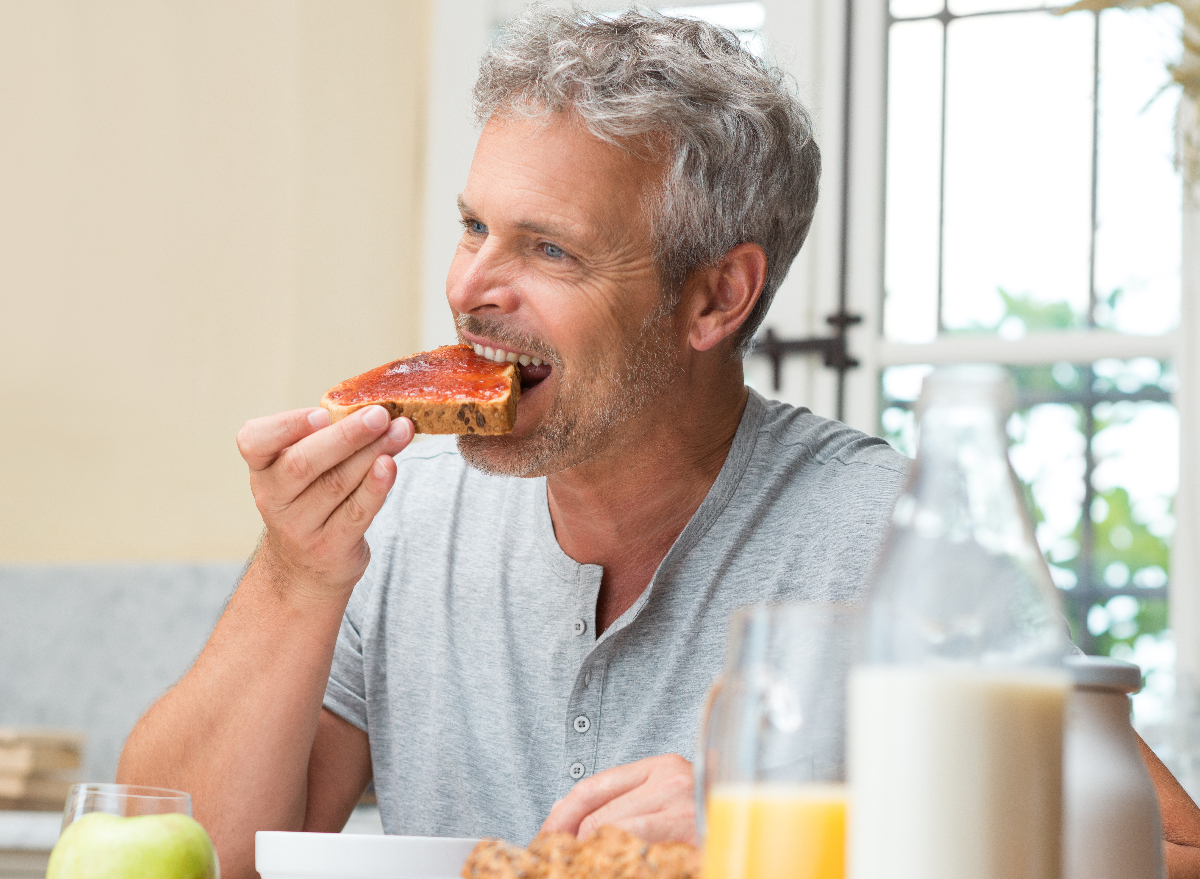 man eating toast with jam, concept of foods preventing you from losing weight after 50