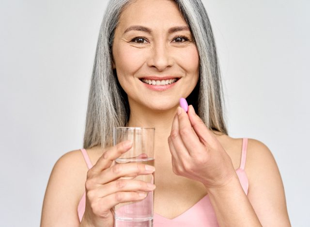 mature woman taking supplements