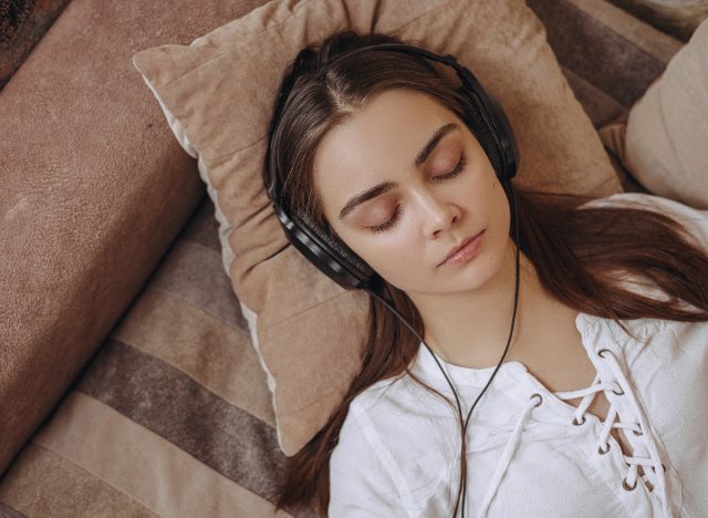 peaceful woman relaxing on brown couch, concept of what is brown noise