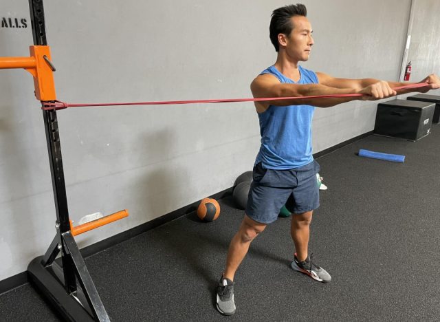 trainer demonstrating resistance band chops