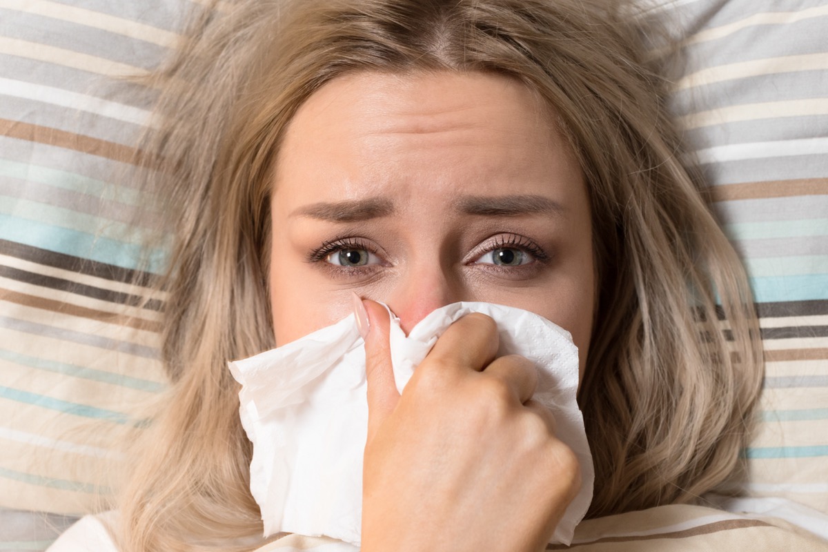 Young,European,Upset,And,Sick,Woman,With,Paper,Napkin,Blowing
