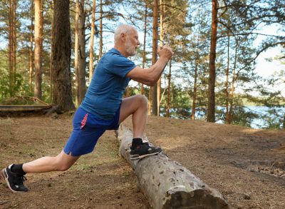 active senior man in woods demonstrating exercises to regain balance after 60