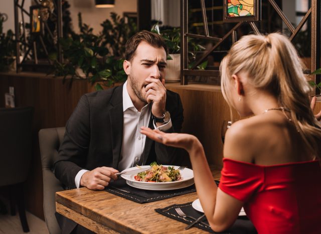 man yawning while out on a dinner date