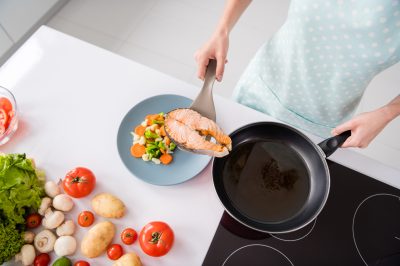 cooking a grilled salmon fillet and veggies