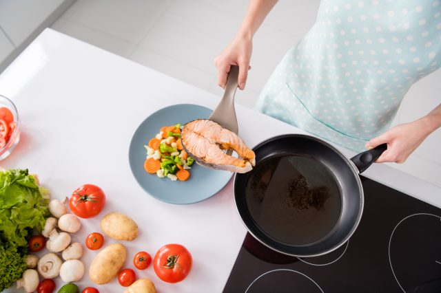 cooking a grilled salmon fillet and veggies