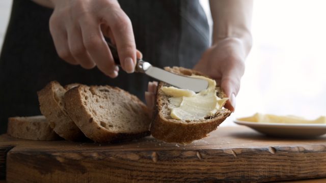 Buttering sourdough bread