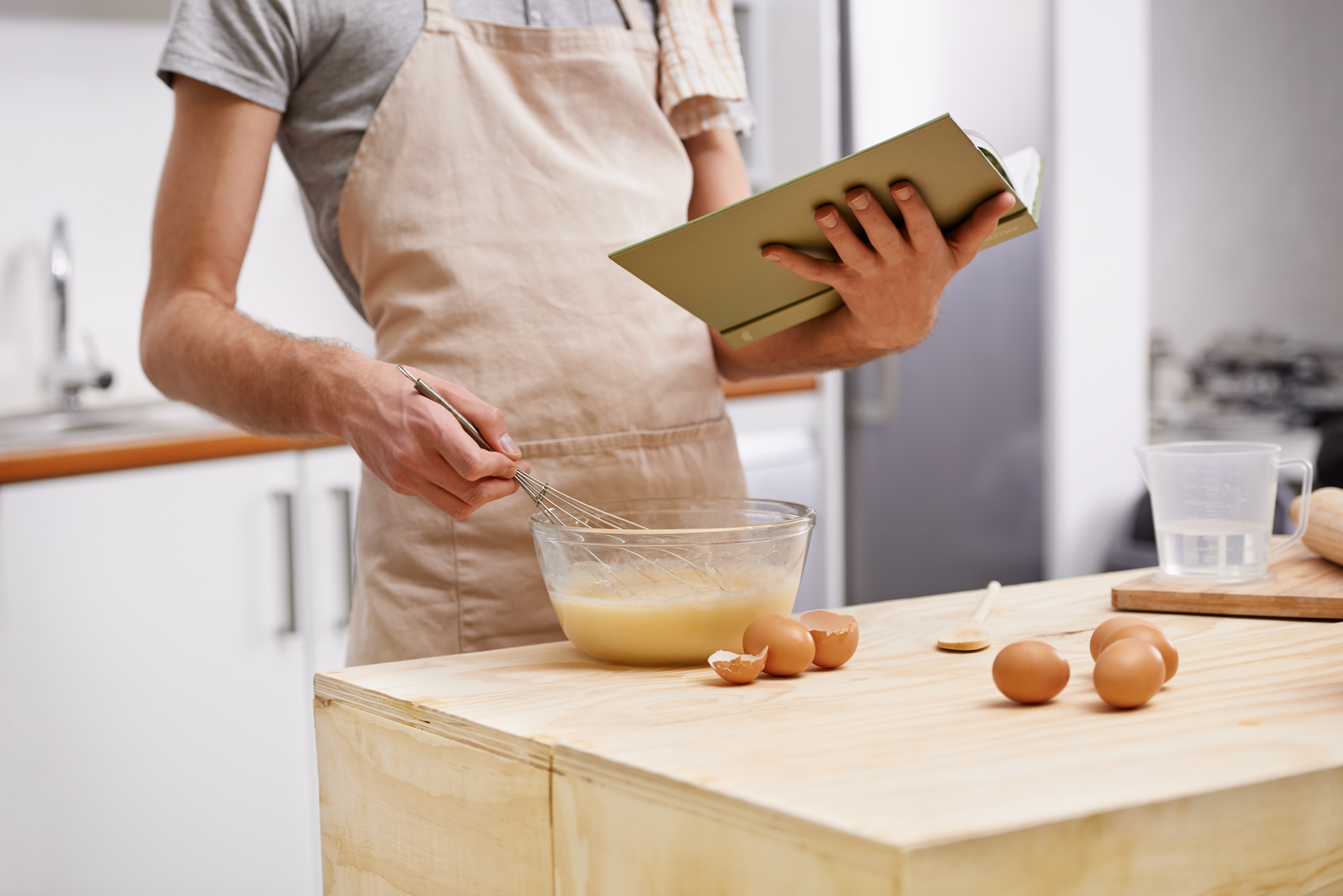 whipping up a recipe using a cookbook