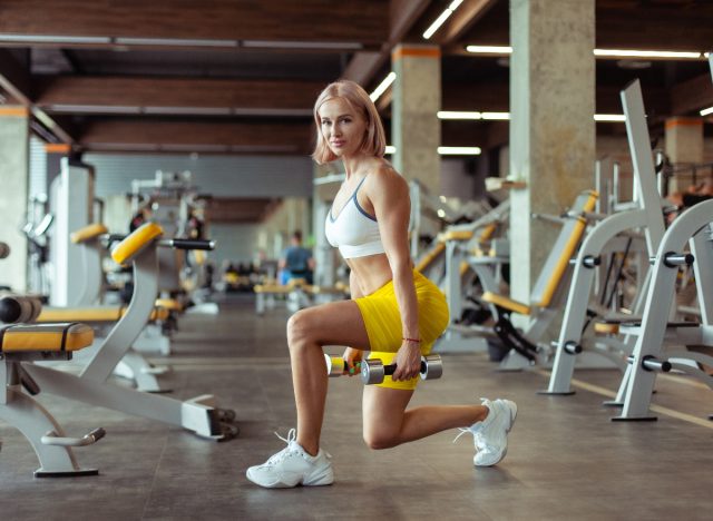 woman demonstrating lunges with dumbbells to boost your muscular endurance