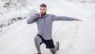 man performing split squat lunges exercises for chicken wings in the snow