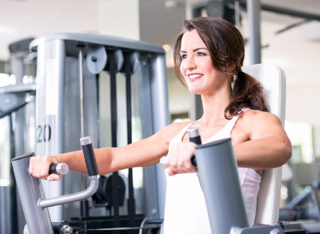 woman on chest press machine