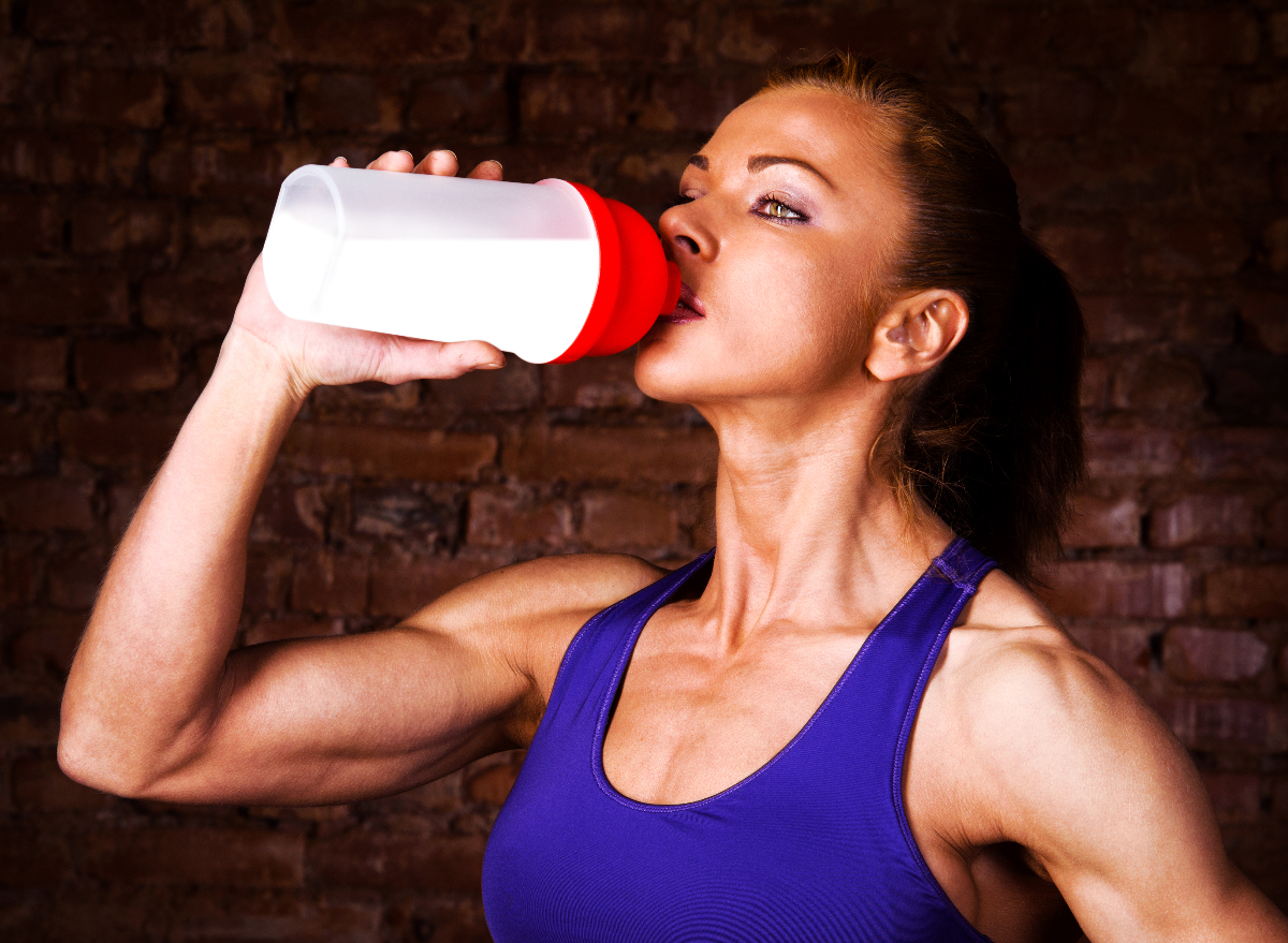 woman drinking protein shake to build muscle after weight loss