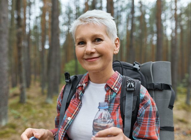 woman demonstrating drinking water and staying hydrated to transform your body after 60