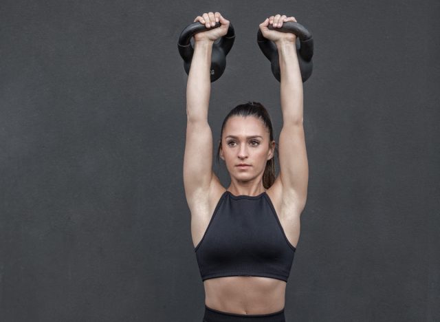 woman kettlebell overhead press