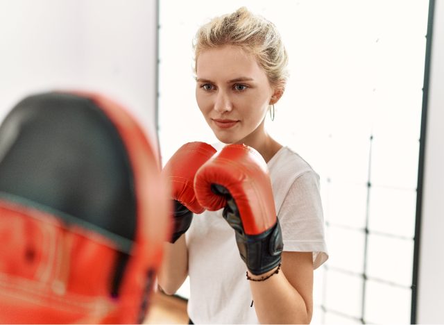 woman kickboxing at home