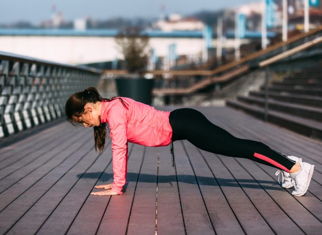 woman outdoors performing pushups weight loss workout for beginners