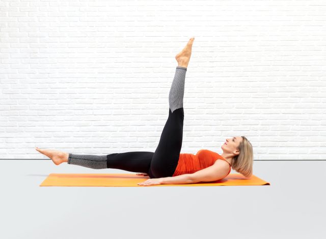 woman doing pilates scissors exercise