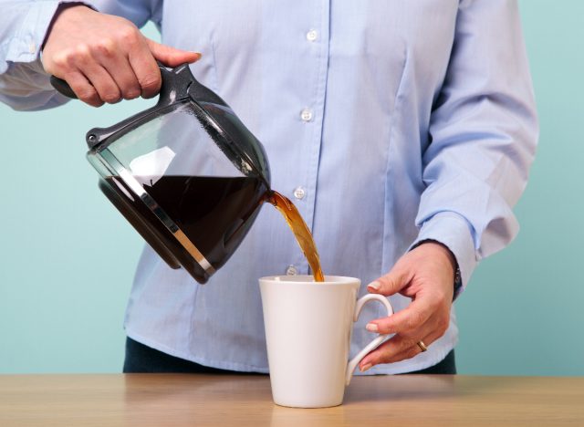 woman pouring herself coffee