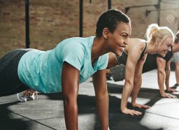woman performing pushups weight loss workout for beginners in exercise class