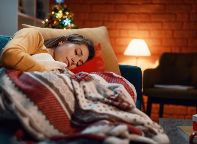 woman sleeping on sofa during Christmas