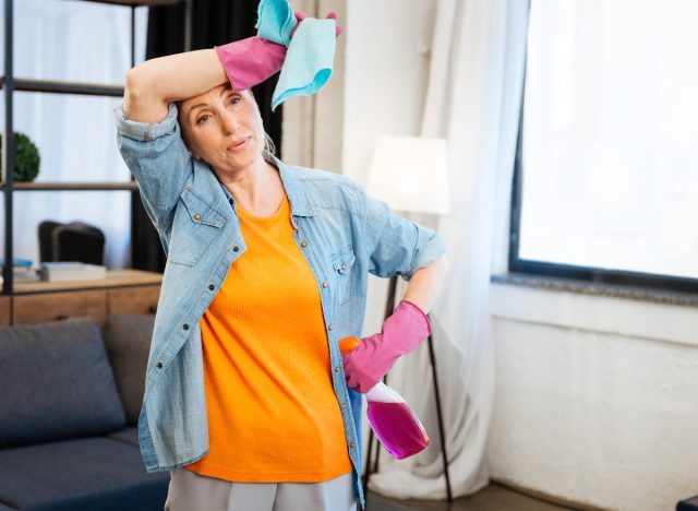 woman tired while doing cleaning at home, concept of signs you need to lose weight
