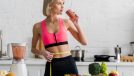 woman dieting for weight loss concept, drinking smoothie in kitchen