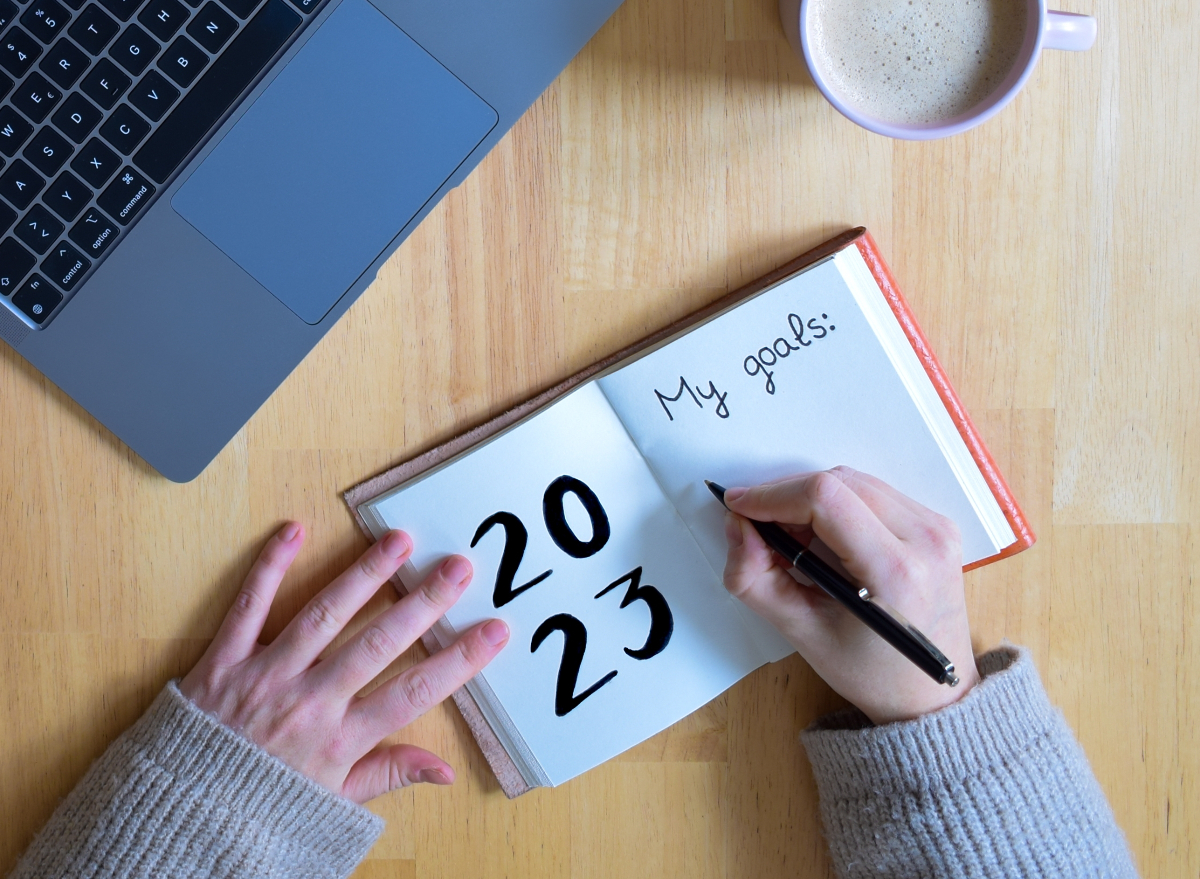 woman writing 2023 goals