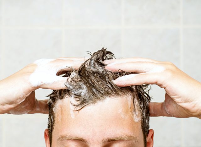 close-up of man washing his hair with shampoo