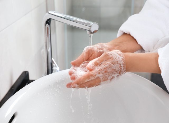 close-up woman washing her hands, concept of bad hygiene habits, not washing hands enough