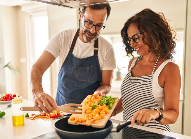 couple cooking healthy meal, demonstrating ways to stay healthy without exercising