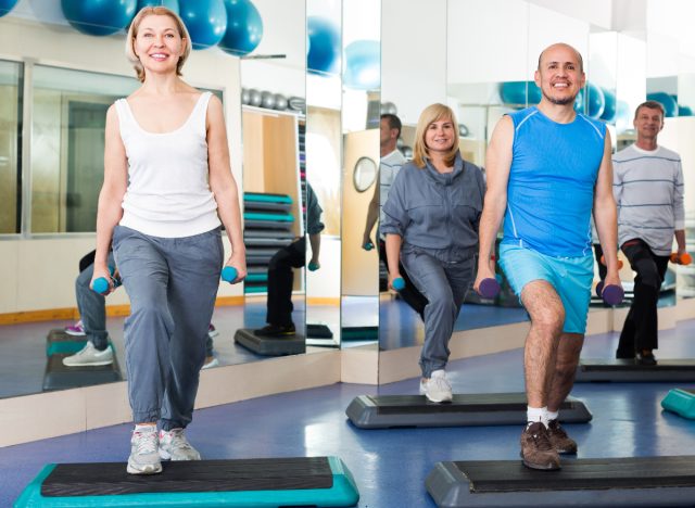 woman in fitness class doing step-ups