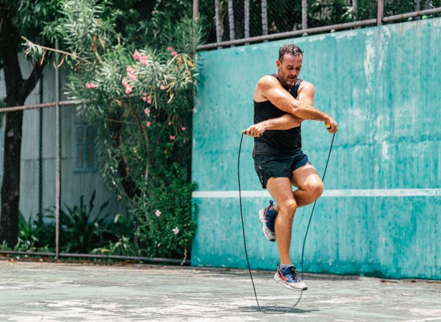 fitness man jumping rope outdoors, demonstrating how to regain muscle mass