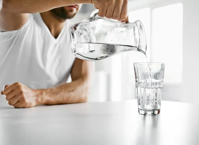 man pouring a glass of water