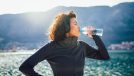 fitness woman drinking water on a run, concept of everyday habits for a flatter stomach that are easy