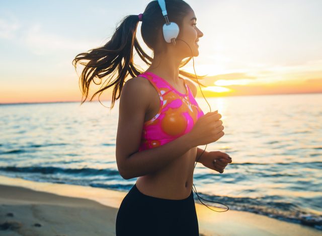 fitness woman jogging at the beach, demonstrates benefits of jogging 10 minutes a day