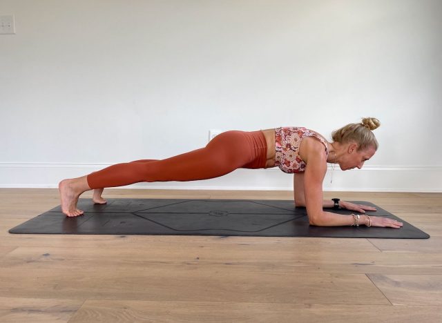 trainer demonstrating forearm plank