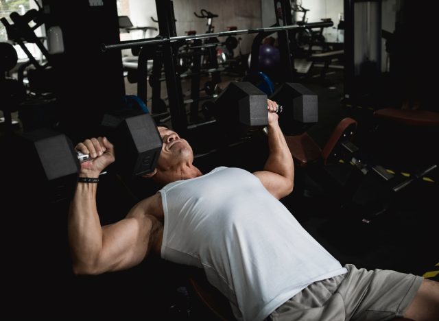 incline dumbbell bench press exercise at gym