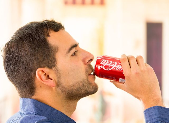 man drinking soda