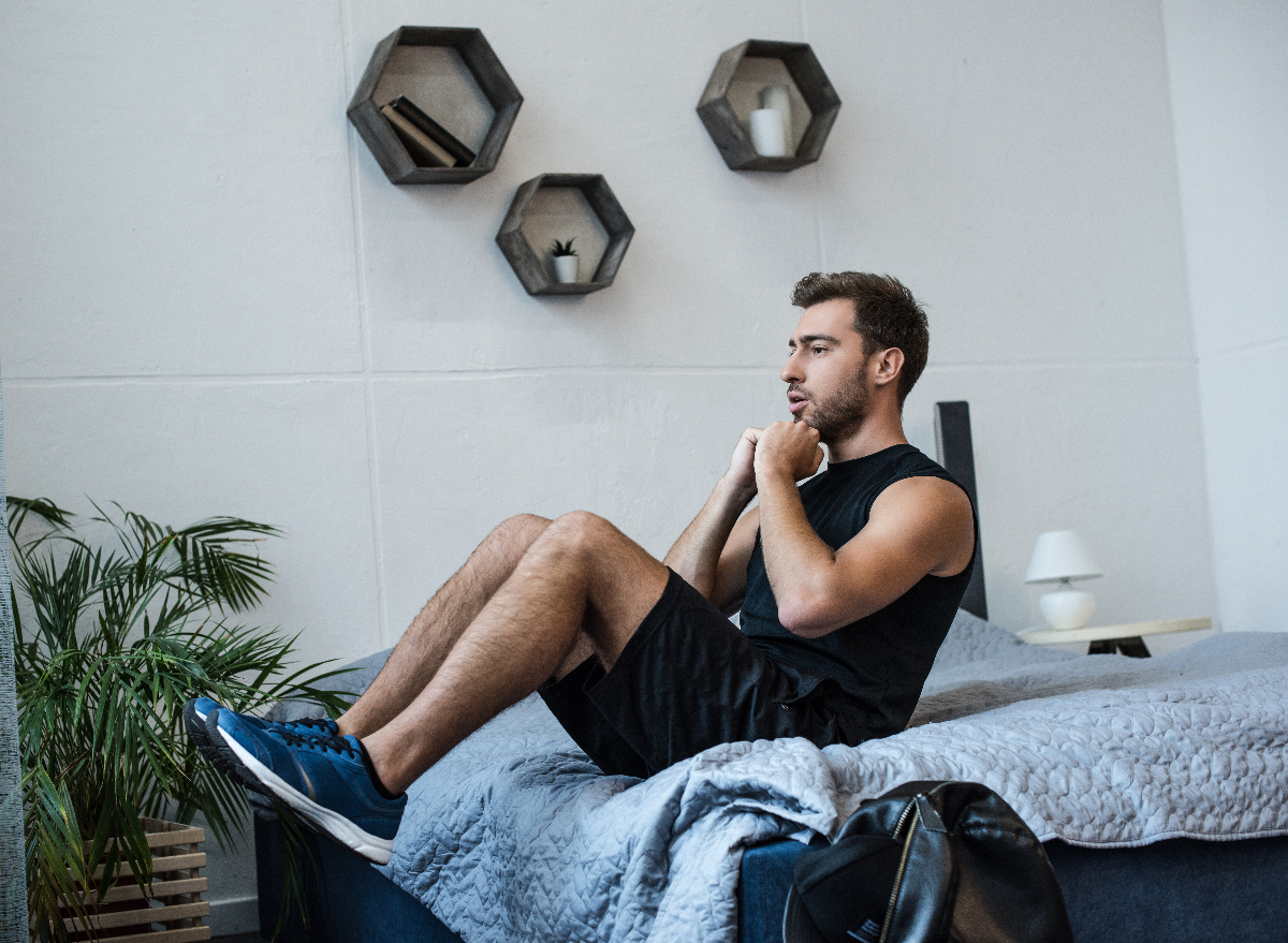 man doing fat-burning exercises in bed