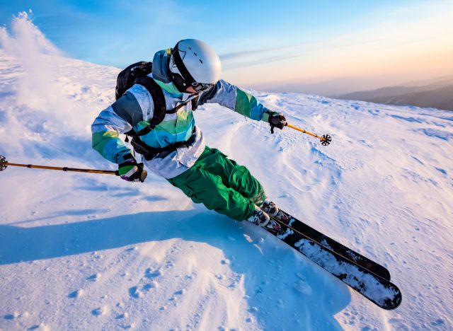 man skiing snowy slopes, stretches to do after skiing concept