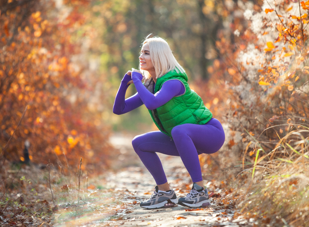 fitness woman doing squats outdoors, demonstrating exercises to change your body shape after 40