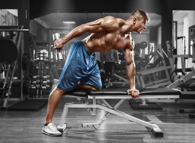 muscular man doing dumbbell rows exercises for men to build muscle