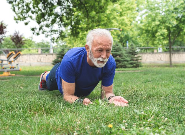 man doing forearm plank, demonstrating back-strengthening exercises for seniors