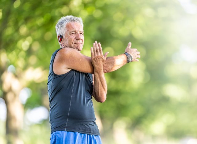 senior man stretching outdoors, concept of fitness habits that destroy your body after 60