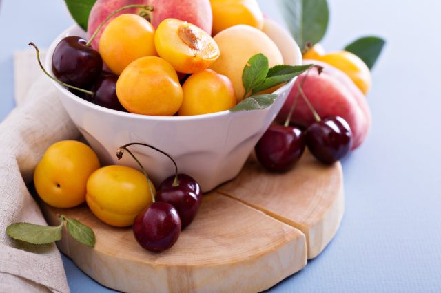 stone fruit_apricots, cherries, peaches in a bowl