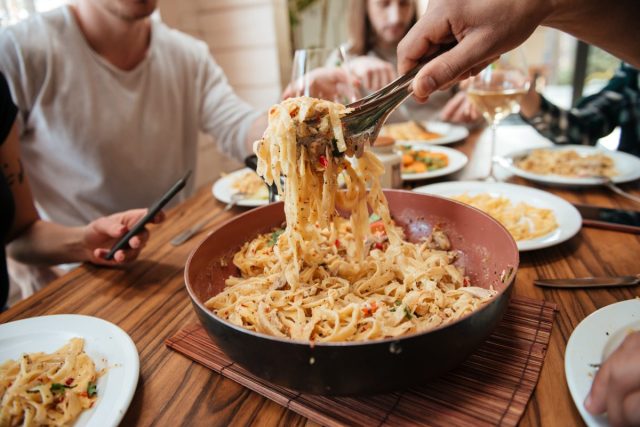 people eating cheesy pasta authentic italian
